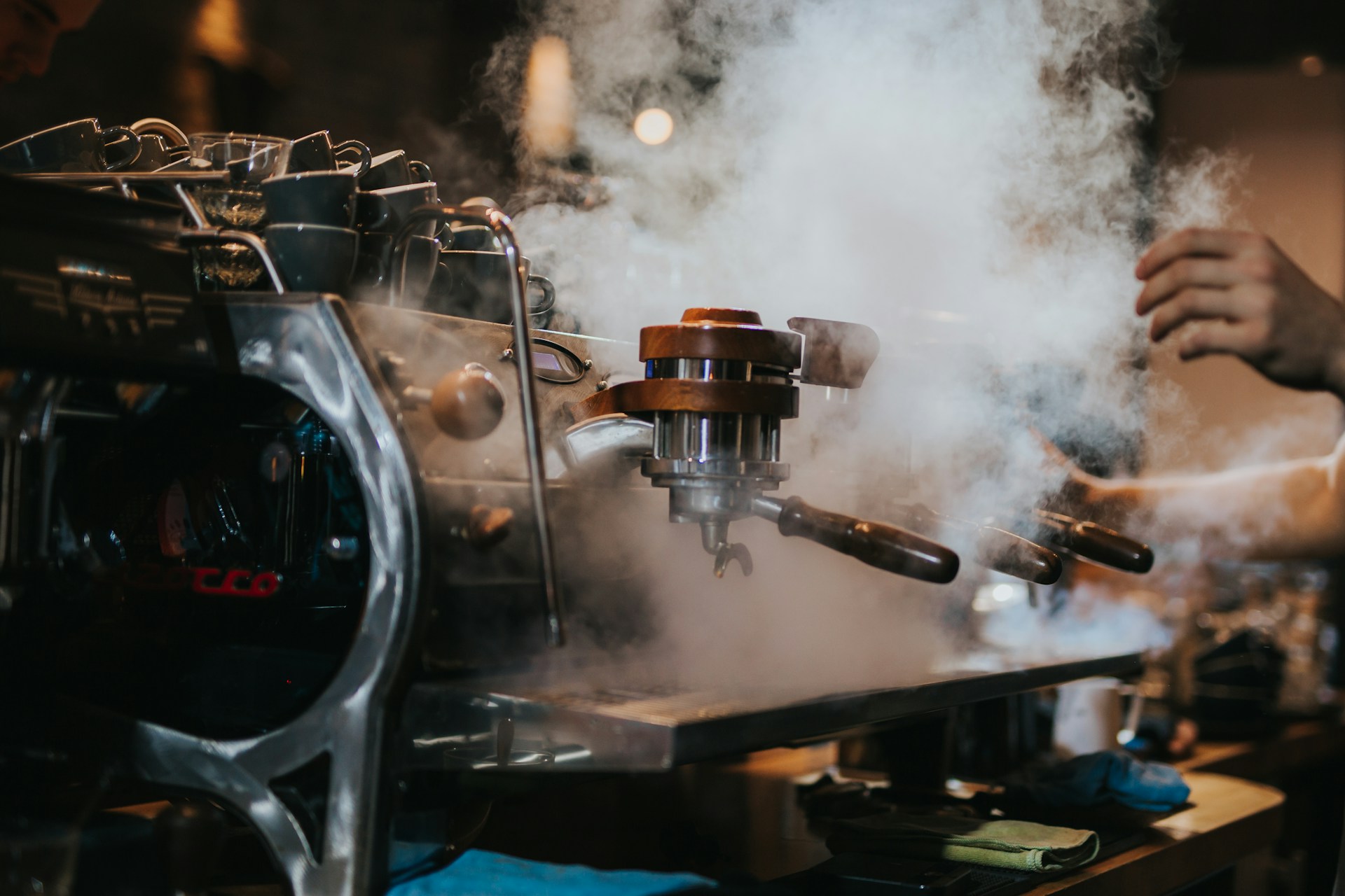 A barista pulling a fresh espresso shot on a commercial machine